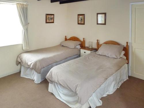 two beds sitting next to each other in a room at Seagull Cottage in Whitby