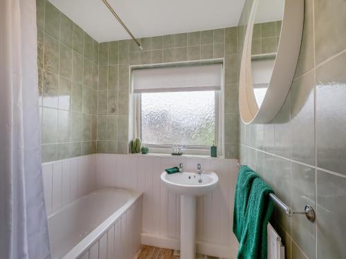 a bathroom with a sink and a bath tub and a sink at Castle View House in Amble