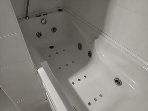 a white bath tub in a bathroom at Casa das Capelas in Villamarín