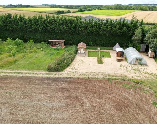 an aerial view of a farm with a tent at Shires Barns in Chippenham