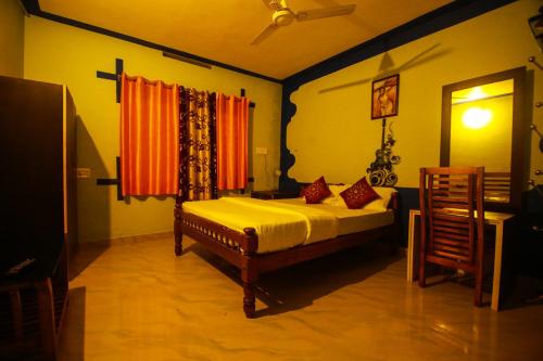 a bedroom with a bed and a television in it at Mount view Holidays in Vagamon