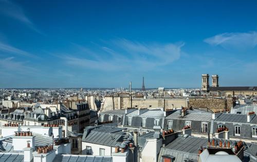 a view of the roofs of buildings in paris at Hotel Flanelles Paris in Paris