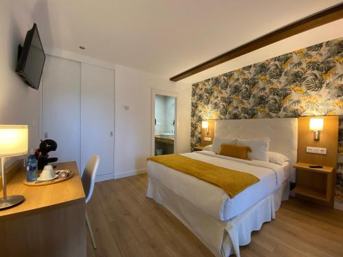 Postel nebo postele na pokoji v ubytování Hotel Rural - El Rincón de Don Pelayo