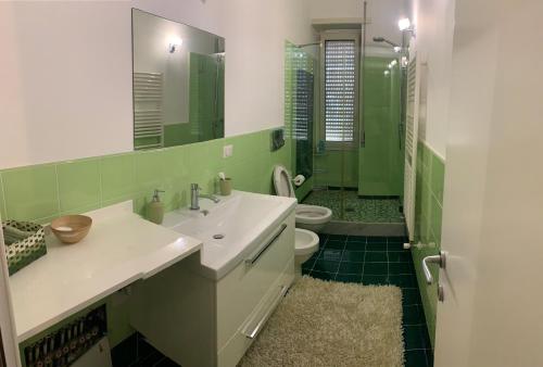 a bathroom with a sink and a toilet and a mirror at Mary's House in Rome