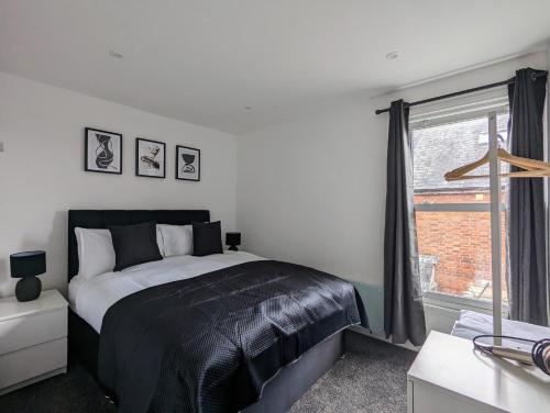a bedroom with a bed and a window at Conegra Road by Wycombe Apartments in High Wycombe
