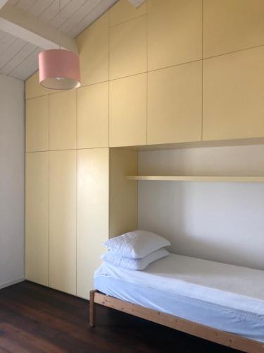 a bedroom with a bed and a pink lamp at ATTICO Rimini Centro - Palacongressi in Rimini