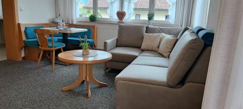 a living room with a couch and a table at Haus Eggensberger in Fischen