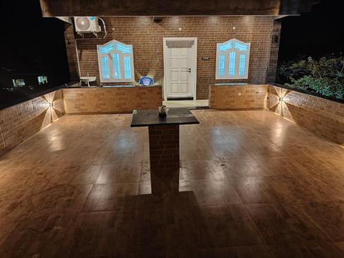 a large empty dance floor with a table in the middle at Treva Pent House in Karaikal