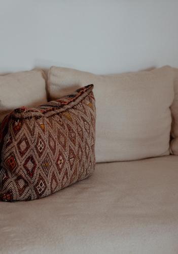 a pillow sitting on top of a couch at Villa Maroc Essaouira in Essaouira