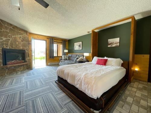 a bedroom with a large bed and a fireplace at Relax, Adventure, Views, Amenities+Memories (Full) in Granby