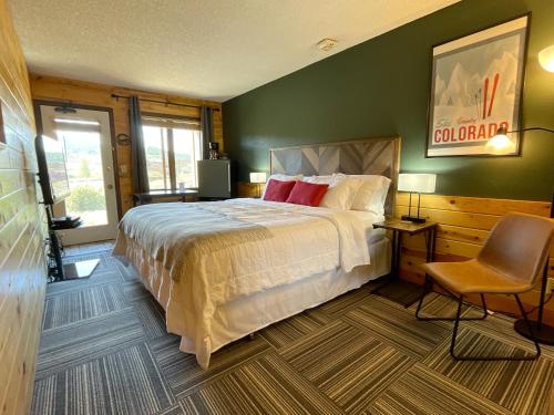 a bedroom with a large bed and a chair at Relax, Adventure, Views, Amenities+Memories (Full) in Granby
