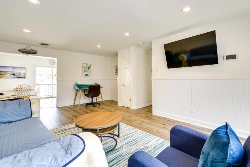 a living room with a blue couch and a table at Charming Beach Haven West Home 1 Mi to Beach! in Manahawkin