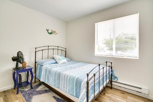 a bedroom with a bed and a window at Charming Beach Haven West Home 1 Mi to Beach! in Manahawkin