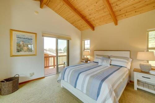 a bedroom with a bed and a balcony at Inviting Manchester Home with Hot Tub Near Beach! in Manchester