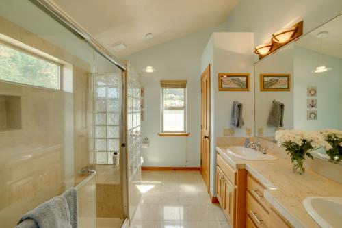 a bathroom with a shower and a sink and a mirror at Inviting Manchester Home with Hot Tub Near Beach! in Manchester