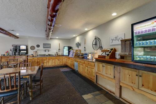 a restaurant with wooden cabinets and tables and a counter at Stoney Creek Hotel Columbia in Columbia
