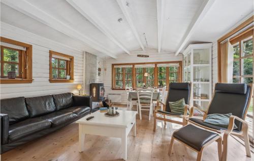 a living room with a couch and a table at Holiday Home Jelsevej Ix in Højslev