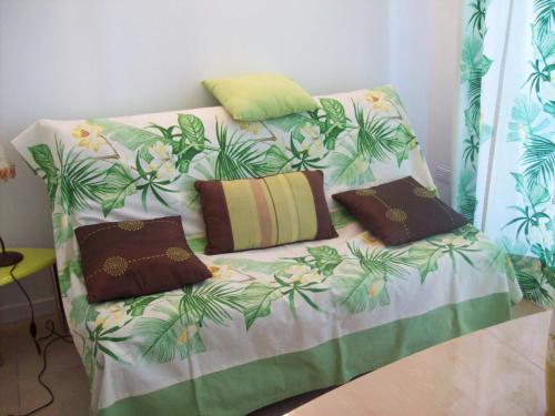 - un canapé avec 3 oreillers dans l'établissement La Corse mer turquoise et sable fin, à Poggio-Mezzana