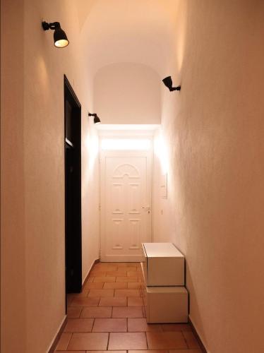 a hallway with a white door and a box at Casa na Vila T2 in Fuzeta
