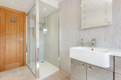 a bathroom with a white sink and a shower at The Bay in Culnacnoc