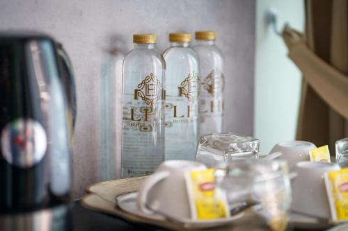 three bottles of water sitting on top of a table at LHC HOTEL AND RESORT in Pattaya Central