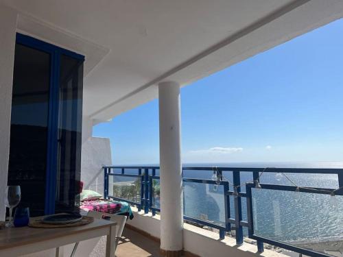 a balcony with a view of the ocean at Stunning sunset ocean view apt. in Taurito