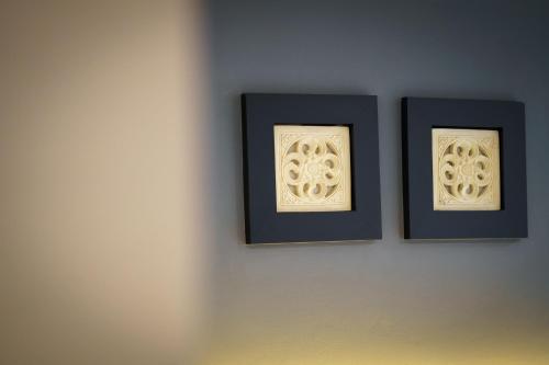 two framed pictures hanging on a wall at LHC HOTEL AND RESORT in Pattaya Central