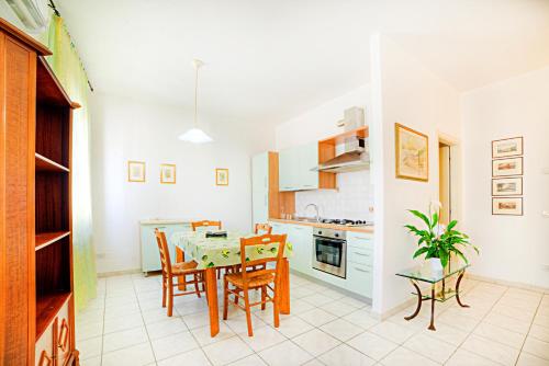 a kitchen with a dining room table and chairs at Cozy Apartment in Castelfiorentino in Castelfiorentino
