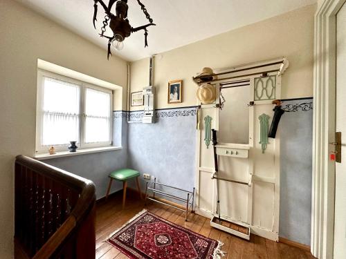 a living room with a refrigerator and a window at Rosi's Ferienwohnung im Haus Sieglinde in Prien am Chiemsee