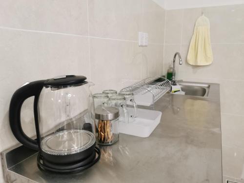 a blender sitting on a counter in a kitchen at THE SHORE KOTA KINABALU - SABAKUBA HOMESTAY (B2010) in Kota Kinabalu