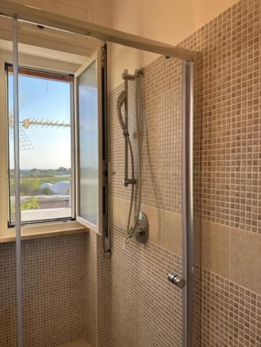 a shower in a bathroom with a window at Casa Lea - Sperlonga in Sperlonga