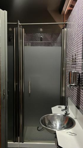 a bathroom with a sink and a shower at Albergue & Cafetería Vía de la Plata Hervás in Hervás