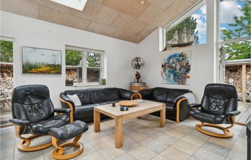 a living room with a couch and chairs and a table at Holiday Home Aresvej Ebeltoft Xii in Ebeltoft