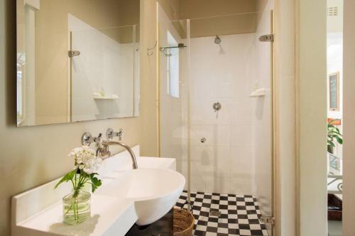 a bathroom with a sink and a shower at Chambery in Cape Town