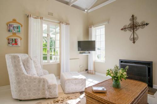 a living room with a chair and a table at Chambery in Cape Town