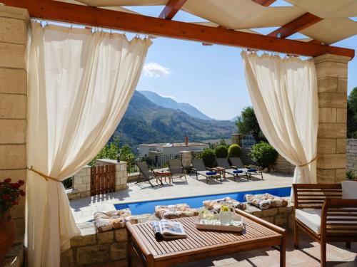 a patio with a view of the mountains at Ageri Traditional Villa in Aryiroúpolis