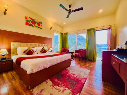 a bedroom with a bed and a ceiling fan at Kempty Myst Resort, Mussoorie - A Comfortable Stay in Mussoorie