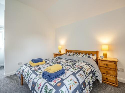 a bedroom with a bed with two towels on it at The Coach House in New Bolingbroke