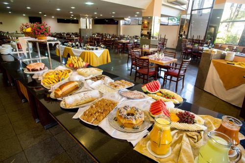 una mesa con muchos tipos diferentes de comida en ella en Hotel Nacional Inn Campinas Trevo en Campinas