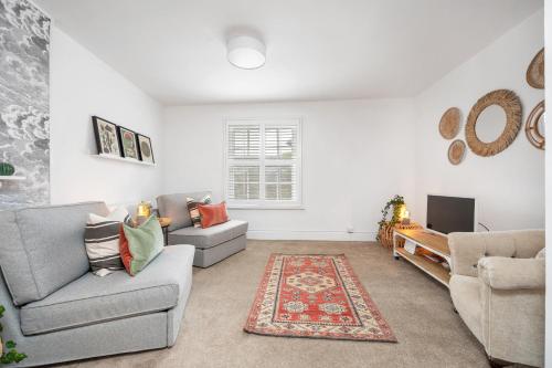 a living room with two couches and a tv at The Limes - Beautiful Townhouse in Oakham in Oakham