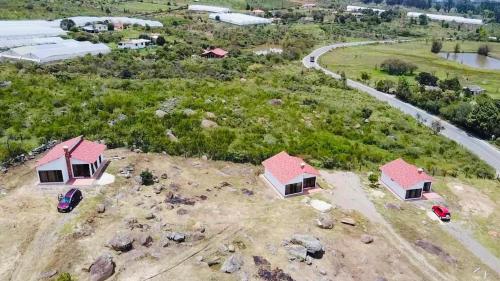 an overhead view of two houses in a field at Cabañas Villa Victoria in Sutamarchán