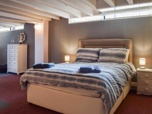 a bedroom with a bed with two blue towels on it at The Pool House in Hale