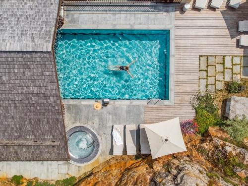 an overhead view of a person swimming in a pool at Armancette - The Leading Hotels of the World in Saint-Gervais-les-Bains