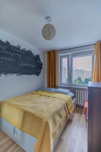 a bedroom with a bed and a large window at Pet’s House Warsaw in Warsaw
