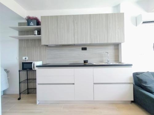 a kitchen with white cabinets and a sink at M Nostrum NY in Málaga