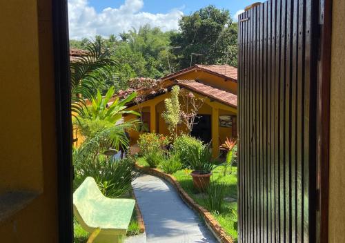 a view of a garden from a window of a house at Pousada Alto da Praia in Arraial d'Ajuda