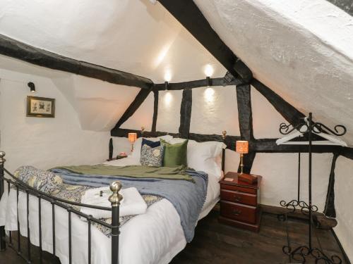 a bedroom with a black and white canopy bed at Avonmede in Tewkesbury