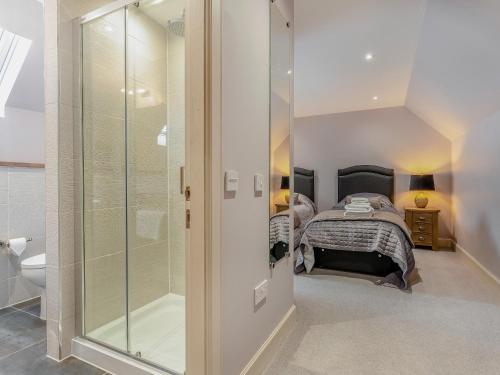 a bathroom with a shower and a bed in a room at Mayflower - Uk43632 in Grange