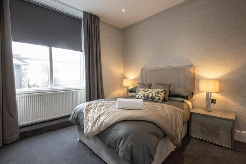 a bedroom with a bed with a laptop on it at The Fort Hotel in Dundee