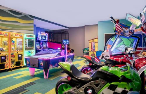 a gaming room with a bunch of games and motorcycles at SpringHill Suites by Marriott Orlando Theme Parks/Lake Buena Vista in Orlando